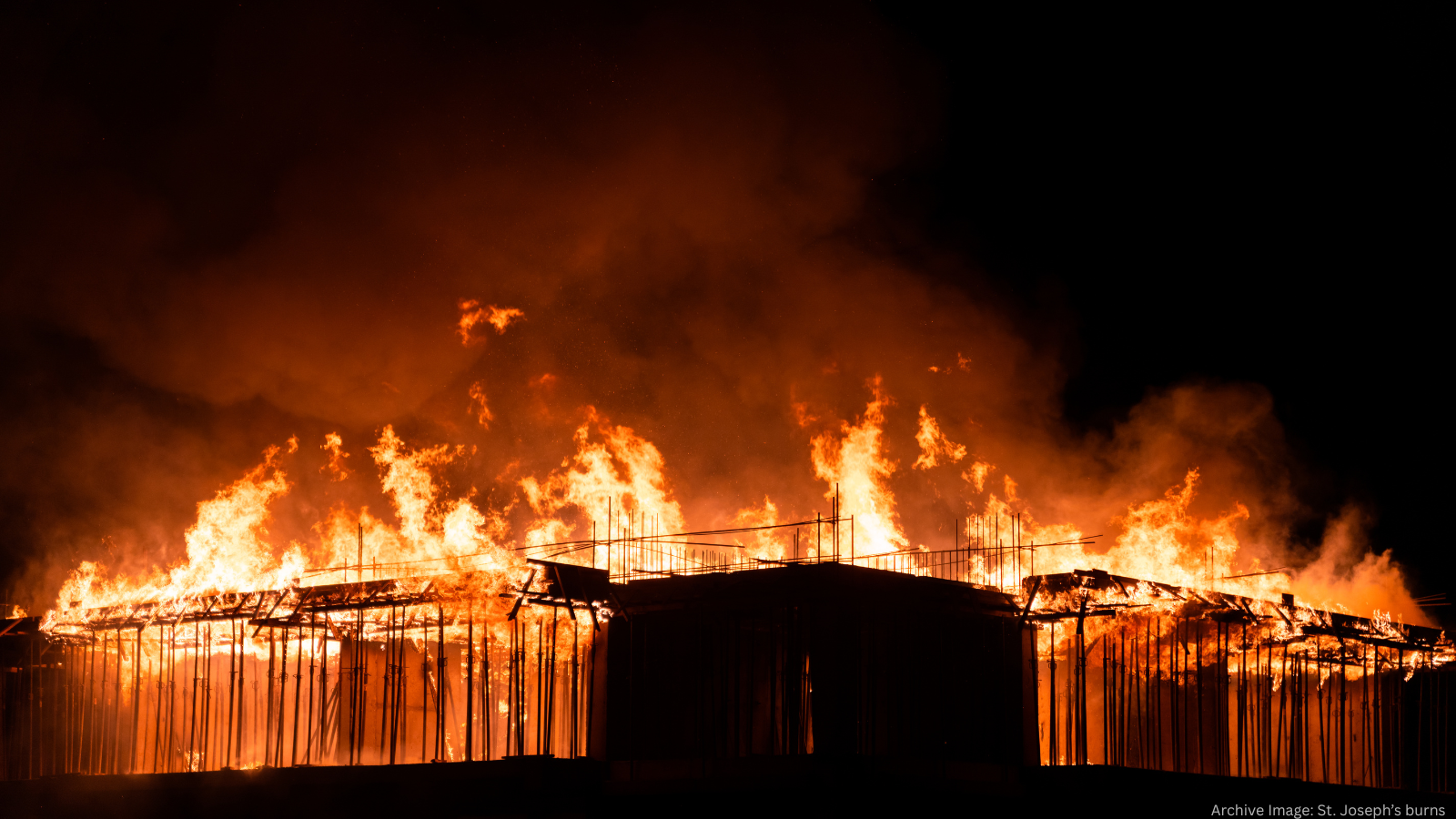 Archive image of smoke and flames consuming the west wing of St. Joseph's.