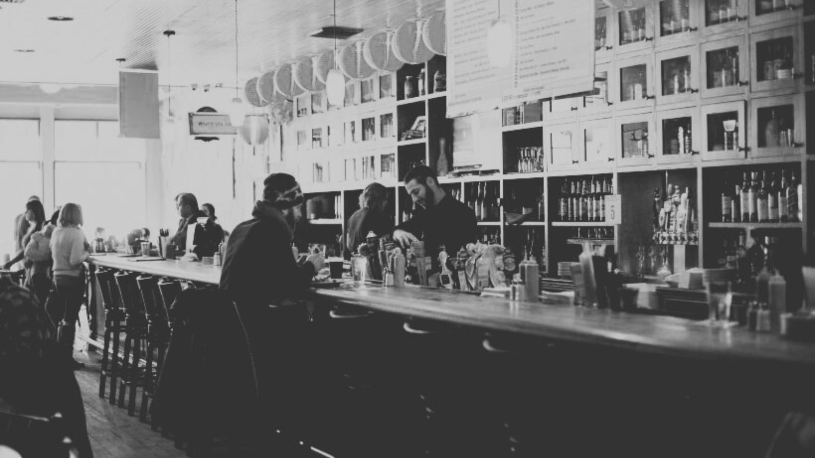 Interior of O’Leary’s Pub, with patrons seated at the bar.